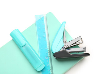 Notebook, stapler and ruler on white background