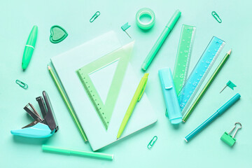 Different stationery supplies on blue background