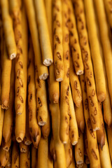 Thin and long bread sticks made of wheat flour on the table