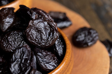 Black pile of prunes from a large number of ripe plums