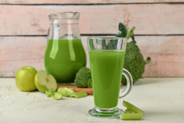 Glass of tasty green juice on grunge table