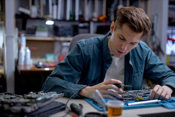 Fototapeta premium young technician or Engineer installing CPU microprocessor to motherboard socket on workplace in the office. Concept of repairing, upgrade, service, electronics and technology of computer.