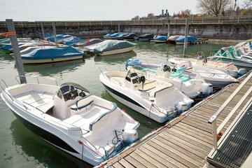 Expensive luxury yachts and boats in the port in the parking lot.