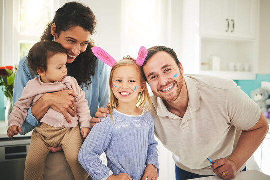 Parents, girl children and bunny ears in portrait in family home with love, baby or happiness for easter. Man, woman and kids in house, laughing and excited for holiday with love, care and bonding