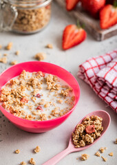 Homemade organic strawberry granola with milk in morning kitchen