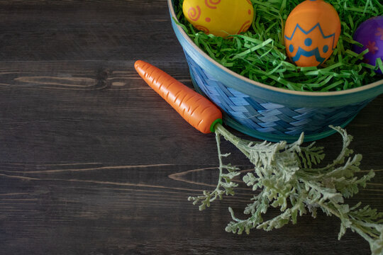 Easter background with copy space with Easter basket with eggs and carrot.