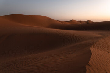 Sunset over sand dunes of Oman