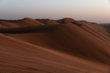 Fototapeta na wymiar Sunset over sand dunes of Oman