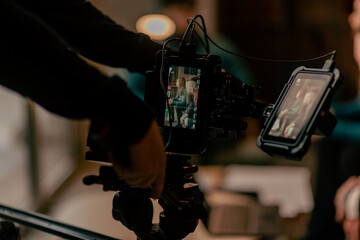 Close up shot of camera man shooting business session. Look through camera