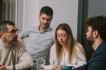 Four business people working together at the office