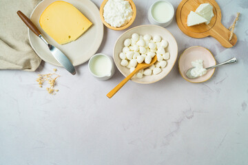 Obraz na płótnie Canvas Dairy products background. Milk, cheese and cottage cheese on stone tabletop. Top view from above