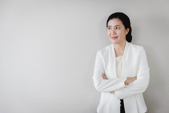 Senior adult Asian businesswoman leader executive company owner standing confident looking out for vision with copy space
