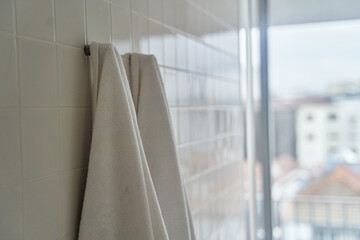 Fototapeta na wymiar Two white towels hanging in the hotel shower room. High quality photo