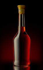 Bottle of unopened premium alcohol, brandy, or cognac on a black background. Ideal for a mock-up design.