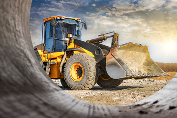 Powerful front wheel loader or bulldozer working on a quarry or construction site. earthworks in construction. Powerful modern equipment for earthworks.