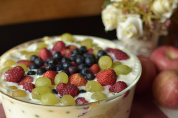 Fresh Fruit on top of Cream Cake with blurry background and shallow depth of field