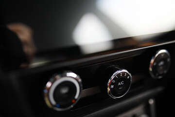The process of choosing climate control in the car. Various controls in auto switches. Modern car interior