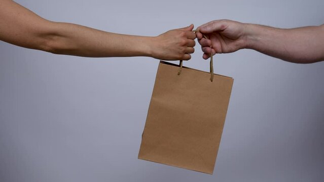 Close up of woman hands receive a shooping bag