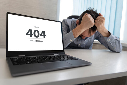 the message on the screen page not found problem with loading the site. Man working on laptop, 404 error, sad man grabs his head with his hands. An enraged programmer at work.