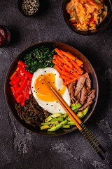 Traditional Korean dish Bibimbap: rice with vegetables beef and egg.