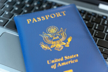 Passport of USA on Notebook keyboard, close up. Identification of the user on the Internet. Prohibition of access to the Internet without passport data. issuing a passport via Internet