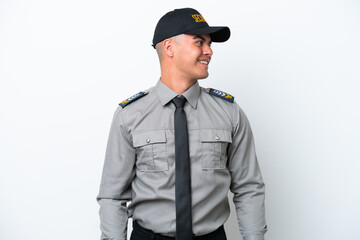 Young caucasian security man isolated on white background looking side