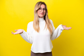 Young Uruguayan woman isolated on yellow background having doubts