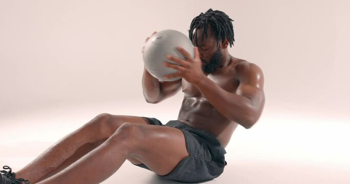 sweaty well-built man sitting on floor doing exercises with ball, close up portrait slow motion endurance lifestyle free spa re time. strong guy using cross fit ball. challenge