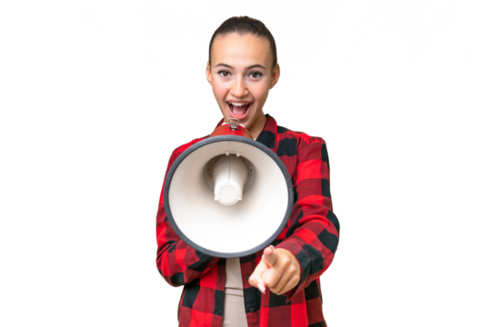 Young Arab woman over isolated background shouting through a megaphone to announce something while pointing to the front
