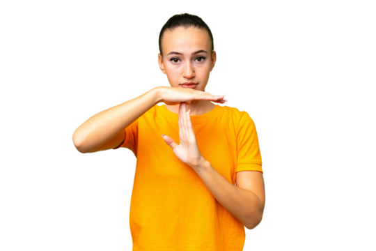 Young Arab woman over isolated background making time out gesture