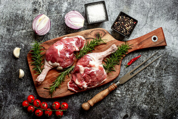 raw duck legs on stone background
