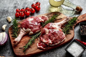 raw duck legs on stone background