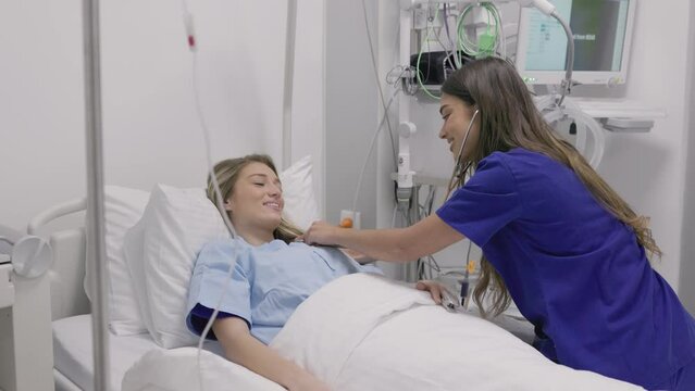 Young patient on bed talking to female doctor in hospital room, Health care and insurance concept. Doctor comforting patient in hospital bed or counsel diagnosis health.