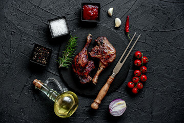 grilled duck legs on a stone background