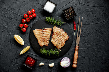 grilled pangasius white fish fillet with spices on a stone background 