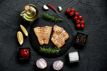 grilled pangasius white fish fillet with spices on a stone background 