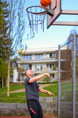 Man playing basketball on a sports field