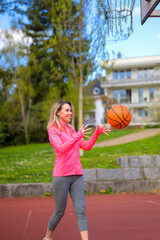 Woman playing basketball on a sports field