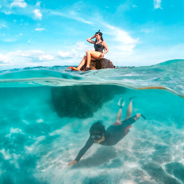 A couple enjoying a beach vacation at a tropical resort with a beautifully landscaped coastal pool at sunset. honeymoon destination at Koh mun nork ,Thailand