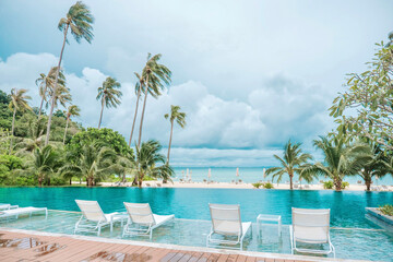 Luxury hotel view, swimming pool corner, white sandy beach, indigo sea, clear water, bamboo walkway...