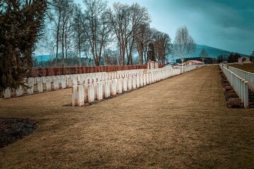 Cemetery tombstones against a gloomy blue sky.