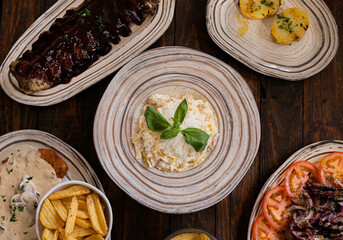 Close-up of asorted dished, cutlet salad ribs fries 