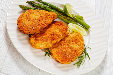 breaded chicken breasts with asparagus and lime