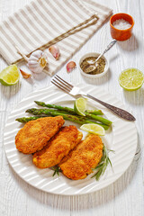 breaded chicken breasts with asparagus and lime