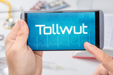 Smartphone mit dem Text Tollwut auf dem Display