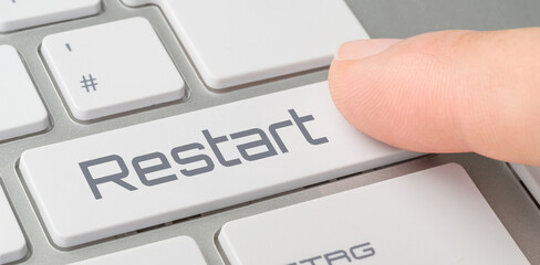 A keyboard with a labeled button - Restart