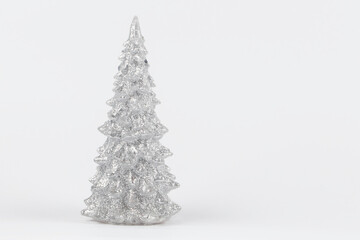 Christmas composition. Silver Christmas tree on a silver background. Happy Holidays. Minimal new...