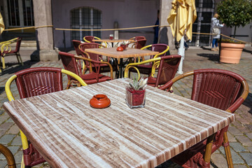 Tables and chairs in a street café restaurant in the old town of lubeck, Germany, copy space,...