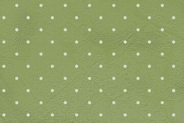 Green paper background with white polka dots.