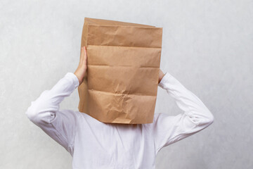 An anonymous man with a box on his head, constricting his identity. Hidden emotions.